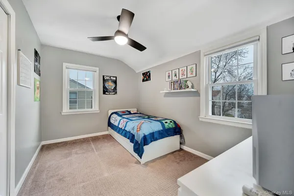 a bedroom with a large bed and a flat screen tv