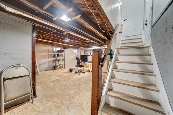 a living room with a bed and a window