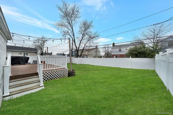 a view of a house with a backyard and a chair