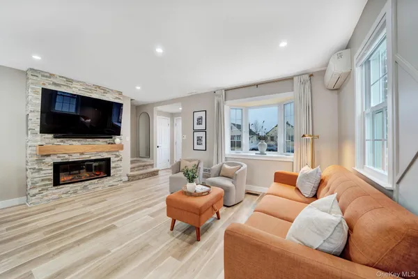 a living room with fireplace furniture and a flat screen tv