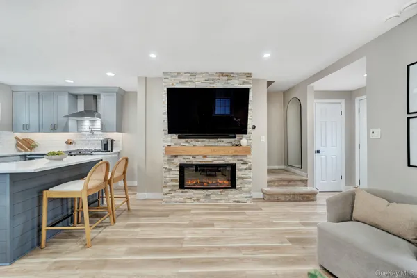 a living room with a fireplace and a flat screen tv