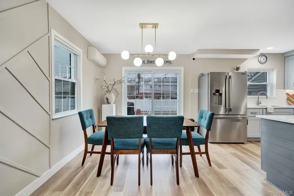 a living room with furniture wooden floor and a window