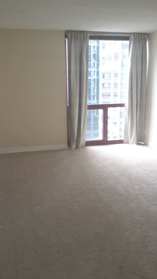 200 North Dearborn Street, Unit 1908 Chicago, IL 60601 - Photo 18 of 23 an empty room with large windows