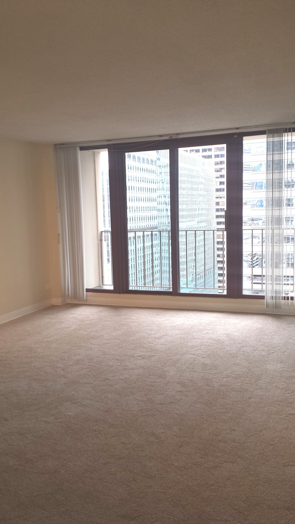 200 North Dearborn Street, Unit 1908 Chicago, IL 60601 - Photo 20 of 23 an empty room with windows