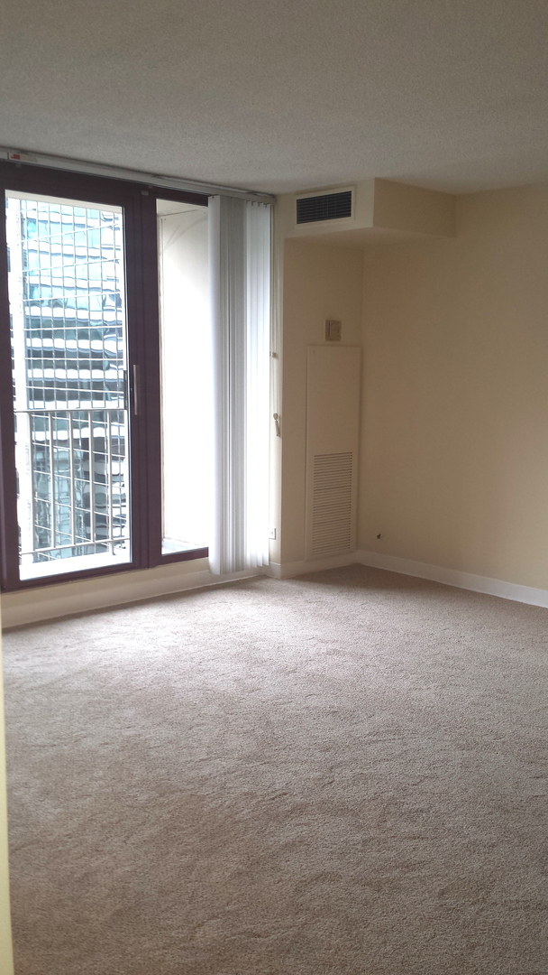 200 North Dearborn Street, Unit 1908 Chicago, IL 60601 - Photo 21 of 23 an empty room with windows