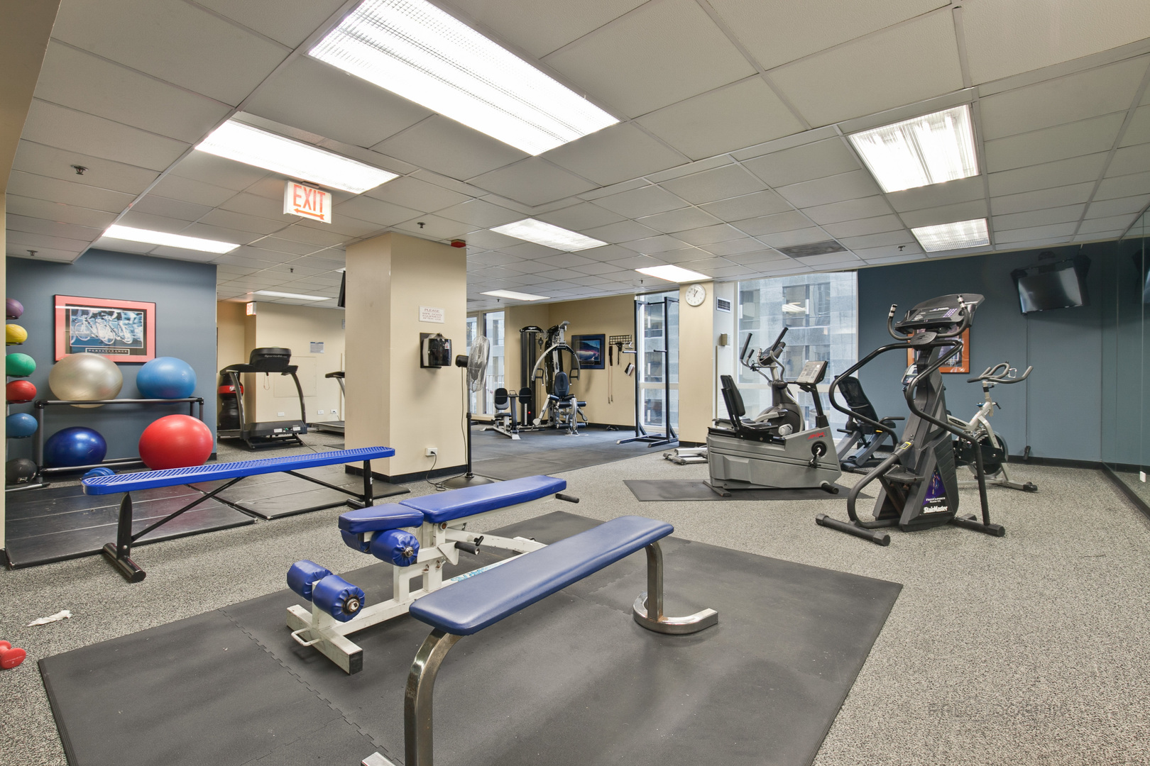 200 North Dearborn Street, Unit 1908 Chicago, IL 60601 - Photo 6 of 23 a room with gym equipment and mirrors