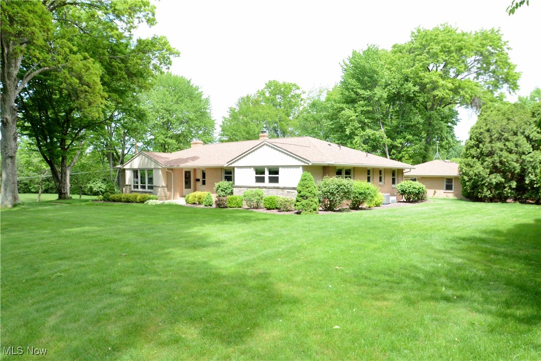 2724 Spitler Road Youngstown, OH 44514 - Photo 3 of 30 Ranch-style home featuring a front yard, a chimney, and stone siding