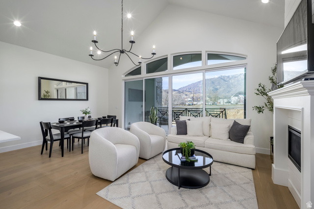 250 South Main Street, Unit 25 Alpine, UT 84004 - Photo 6 of 31 Living area with lofted ceiling, wood finished floors, a glass covered fireplace, and suspended lighting