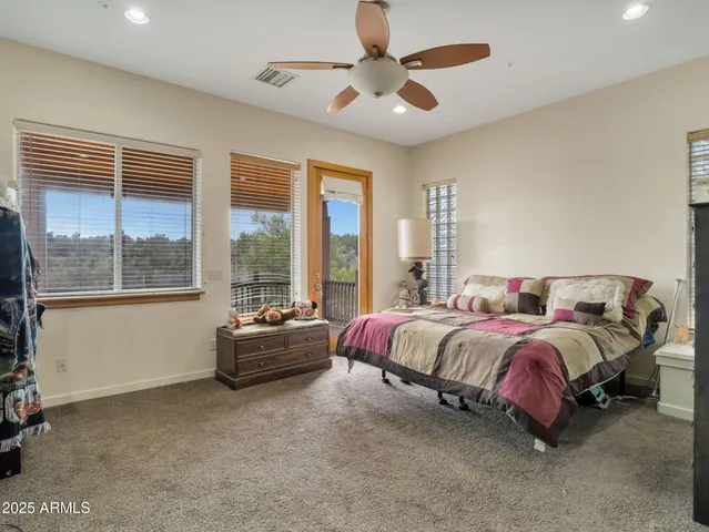 a spacious bedroom with a bed and a large window