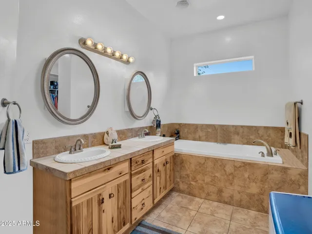 a bathroom with a double vanity sink and a mirror