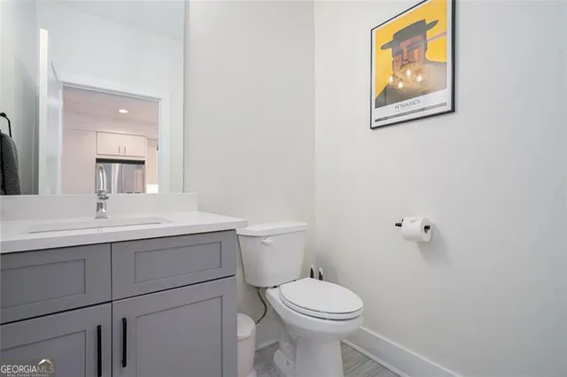 a bathroom with a toilet a sink and mirror