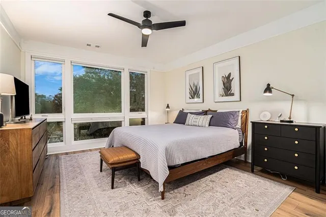 a bedroom with a bed and large window