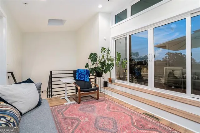 a living room with furniture and a potted plant