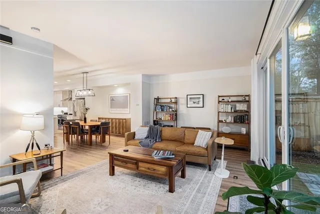 a living room with furniture and wooden floor