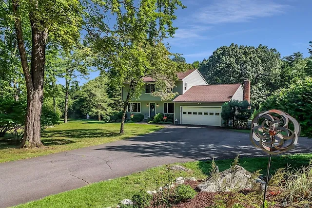a view of a house with backyard and a garden