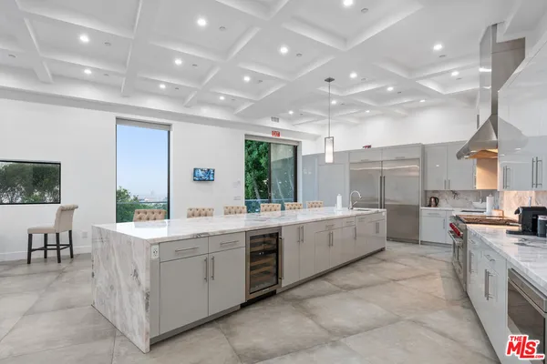 a large kitchen with a table and chairs