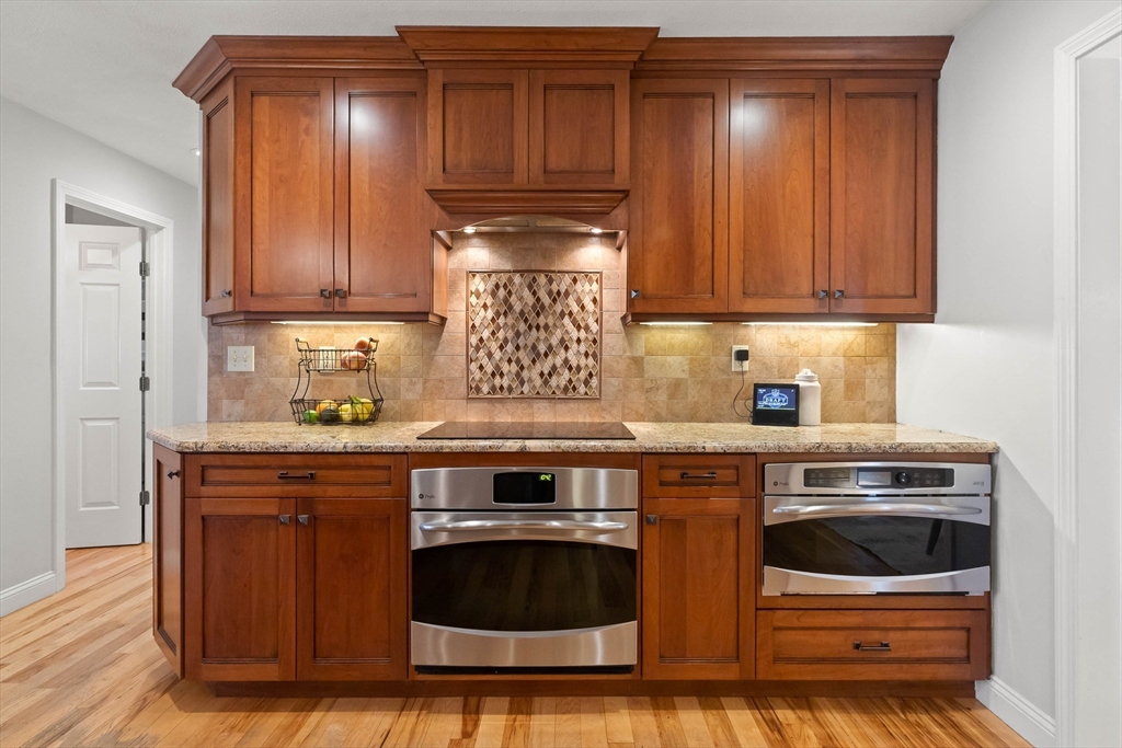 145 River Street Middleton, MA 01949 - Photo 11 of 42 a kitchen with stainless steel appliances granite countertop wooden cabinets and a stove top oven