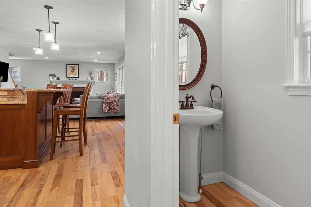 145 River Street Middleton, MA 01949 - Photo 17 of 42 a view of a kitchen from a dining room with wooden floor windows and a kitchen