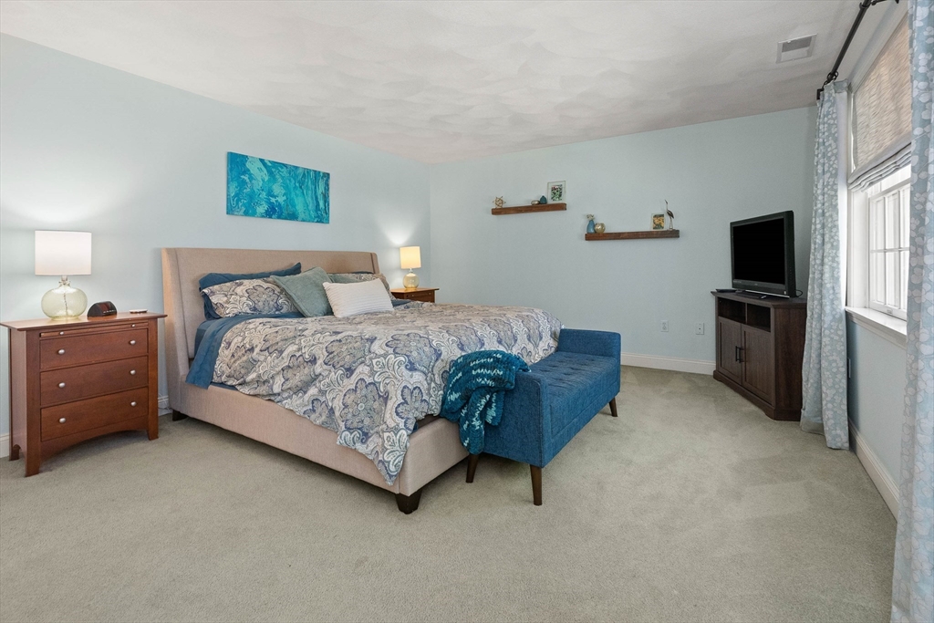 145 River Street Middleton, MA 01949 - Photo 19 of 42 a bedroom with a bed flat screen tv and window