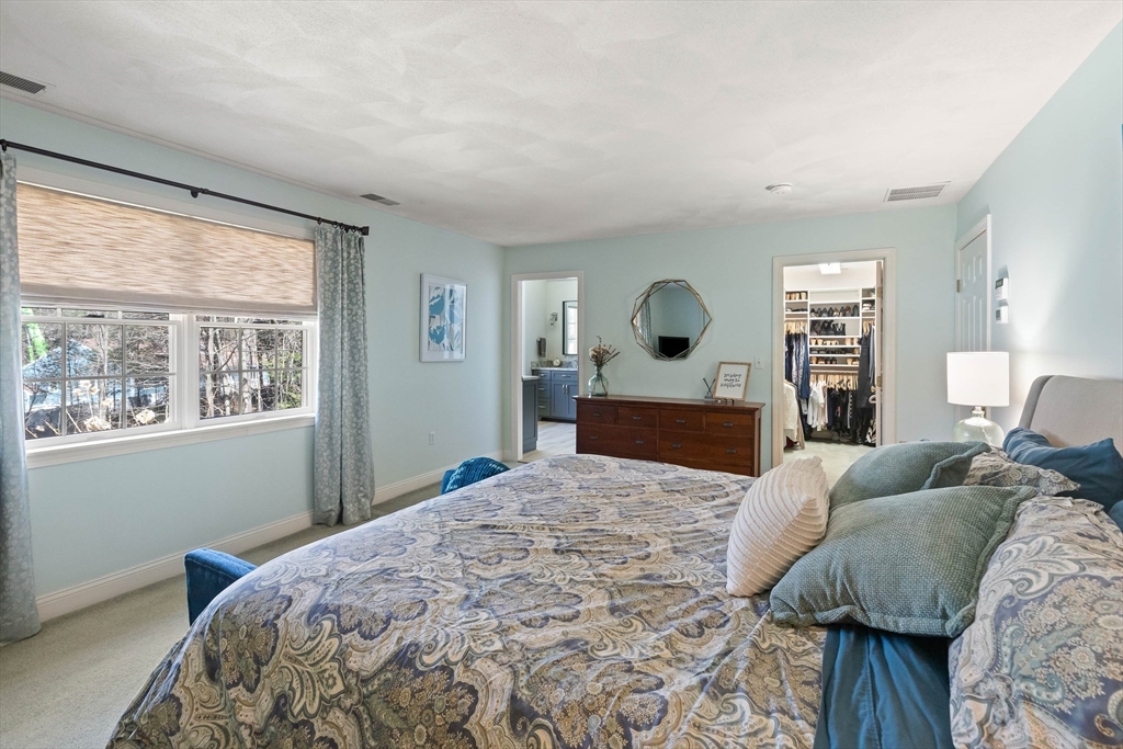 145 River Street Middleton, MA 01949 - Photo 20 of 42 a bedroom with a large bed and a dresser