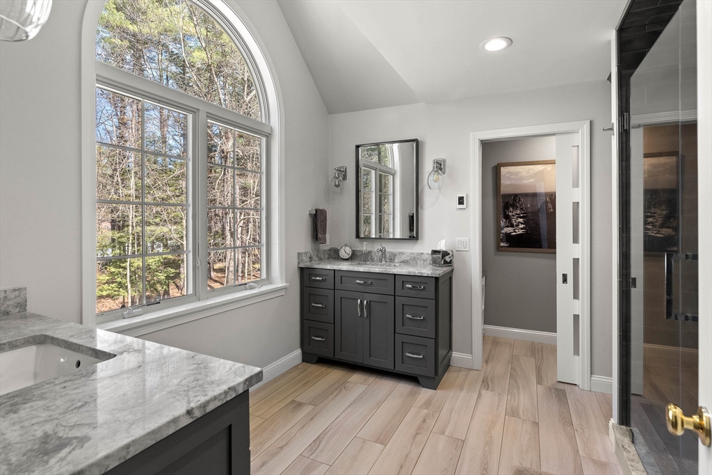 145 River Street Middleton, MA 01949 - Photo 22 of 42 a bathroom with a granite countertop sink mirror and a bath tub