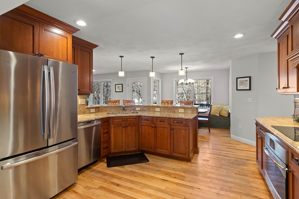 145 River Street Middleton, MA 01949 - Photo 9 of 42 a kitchen with stainless steel appliances granite countertop a refrigerator a sink and a stove