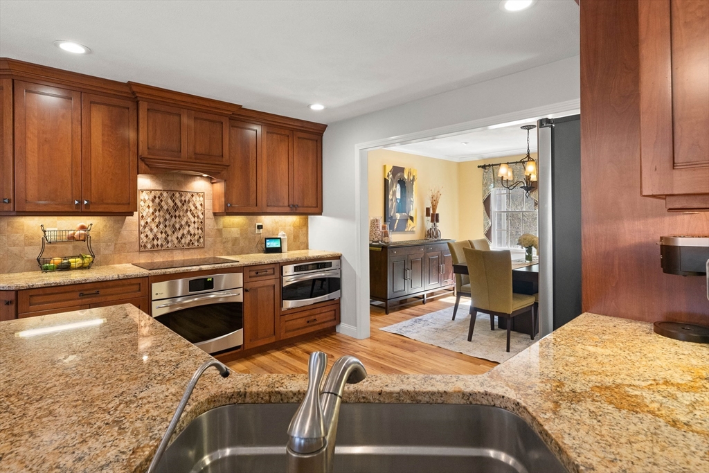 145 River Street Middleton, MA 01949 - Photo 10 of 42 a kitchen with stainless steel appliances granite countertop a stove refrigerator and cabinets