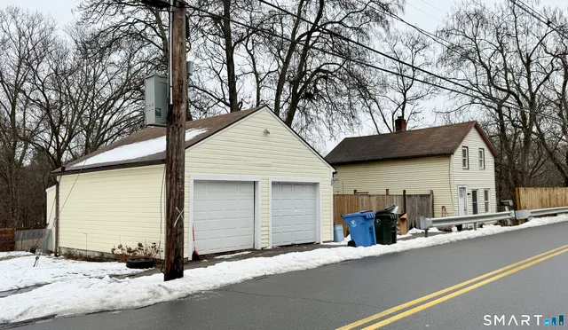 a view of a house with a yard covered in snow