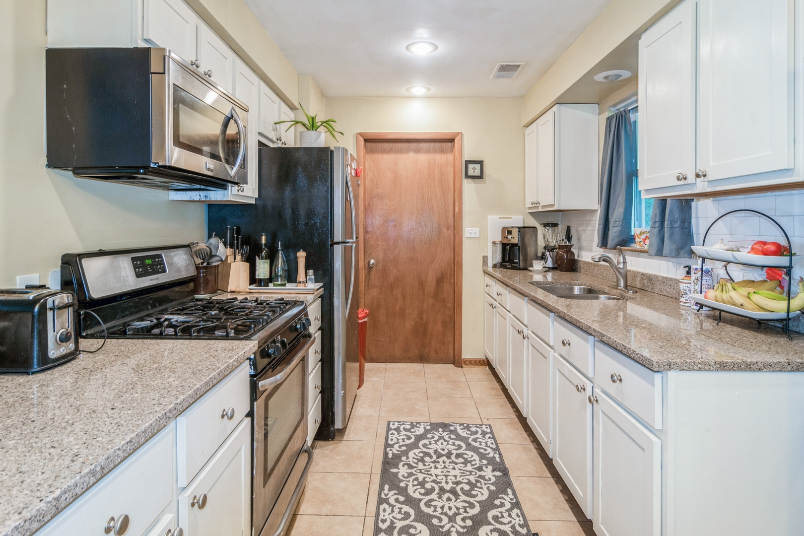 24 North Delaplaine Road Riverside, IL 60546 - Photo 5 of 11 a kitchen with stainless steel appliances granite countertop a stove a sink dishwasher and a refrigerator