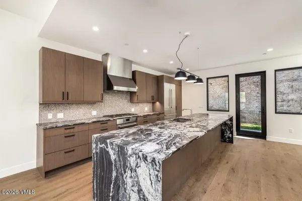 a kitchen with a stove a sink and a refrigerator