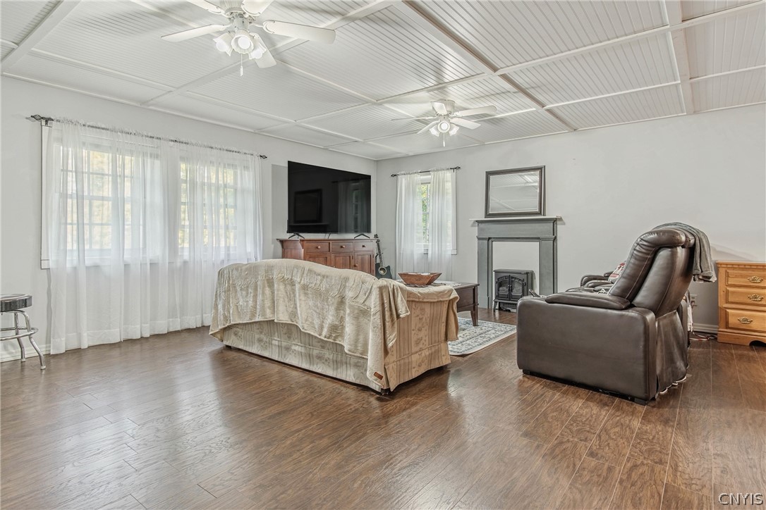 15384 Fuller Road Adams, NY 13606 - Photo 43 of 50 Rich wood flooring runs under a paneled ceiling with dual fans in this inviting living space.