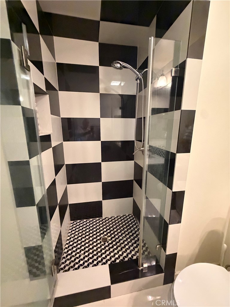 19823 Mariposa Pines Way Porter Ranch, CA 91326 - Photo 36 of 50 a bathroom with a black and white checkered floor