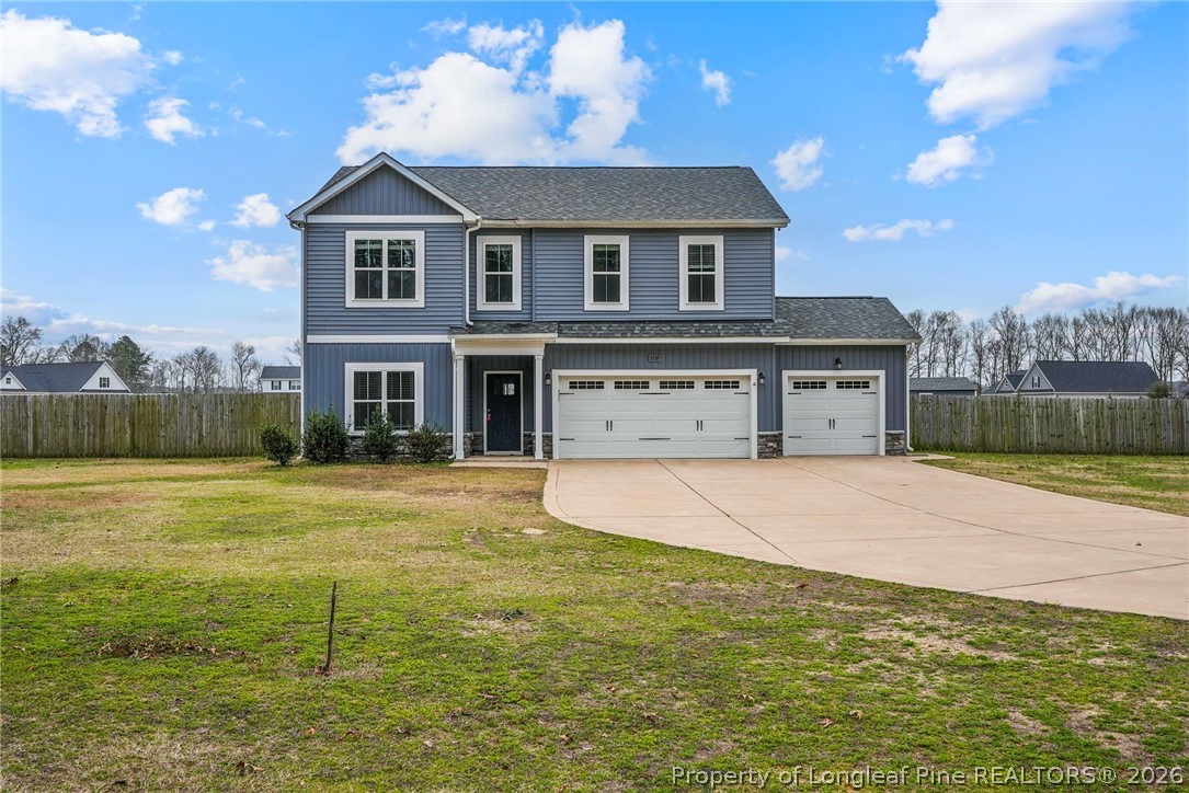 5150 J T Matthews Road Godwin, NC 28344 - Photo 1 of 50 a front view of a house with a yard and garage