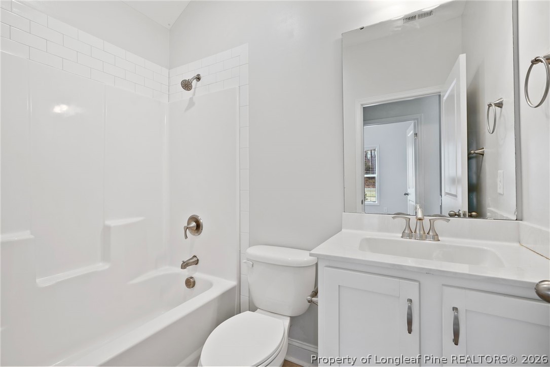 5150 J T Matthews Road Godwin, NC 28344 - Photo 13 of 50 a bathroom with a sink toilet vanity and shower