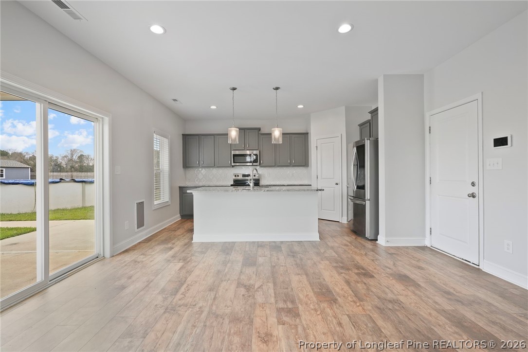 5150 J T Matthews Road Godwin, NC 28344 - Photo 18 of 50 a view of kitchen with stainless steel appliances kitchen island wooden floors and center island
