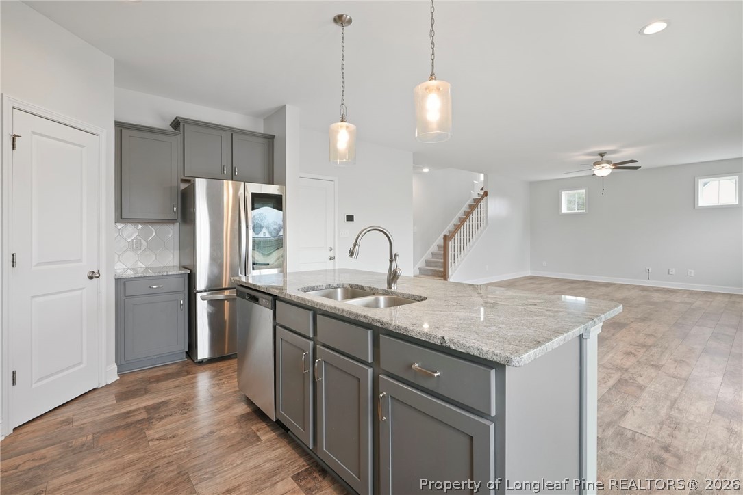 5150 J T Matthews Road Godwin, NC 28344 - Photo 21 of 50 a kitchen with a sink a refrigerator and wooden floor
