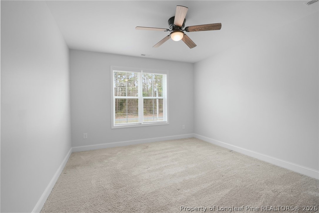 5150 J T Matthews Road Godwin, NC 28344 - Photo 28 of 50 an empty room with a window and a fan