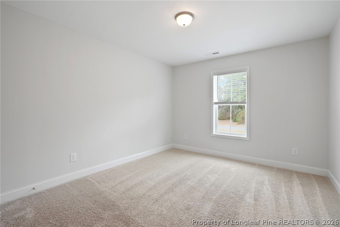 5150 J T Matthews Road Godwin, NC 28344 - Photo 32 of 50 an empty room with windows