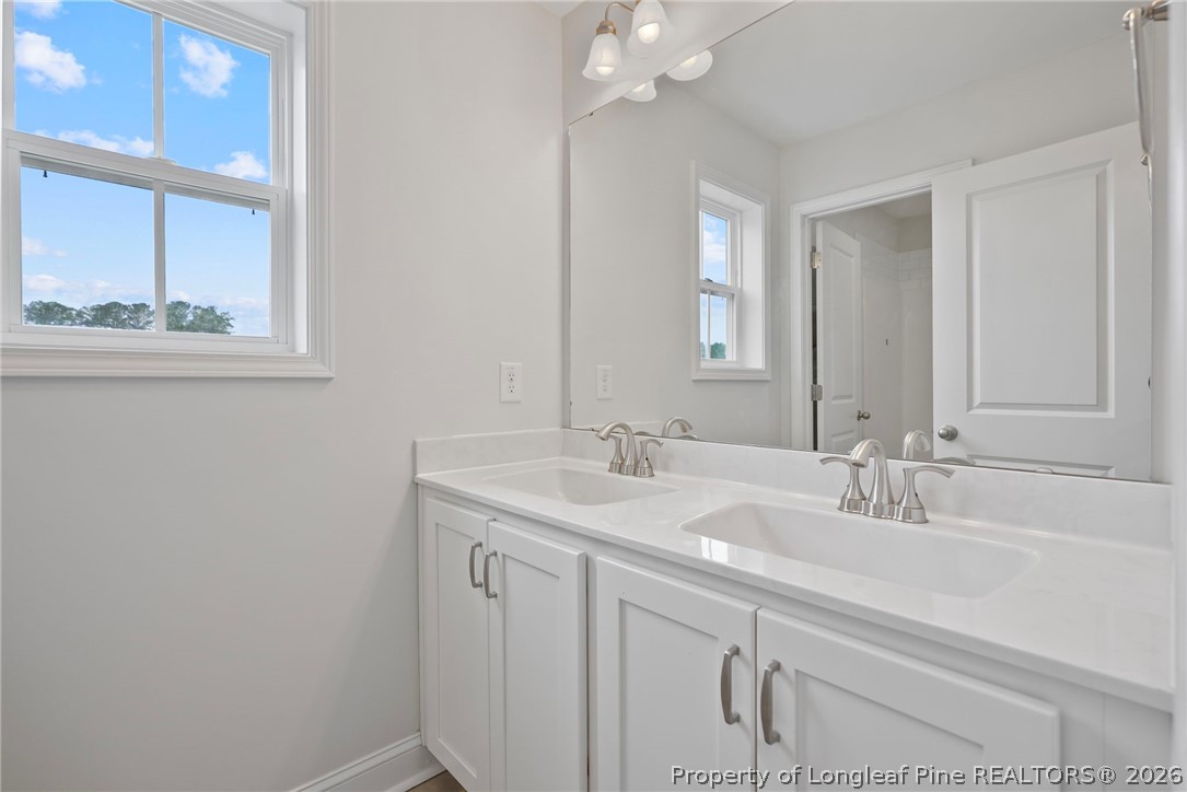 5150 J T Matthews Road Godwin, NC 28344 - Photo 34 of 50 a bathroom with a sink and a mirror