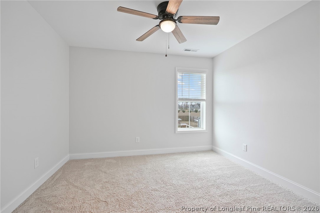5150 J T Matthews Road Godwin, NC 28344 - Photo 38 of 50 an empty room with a window and a fan