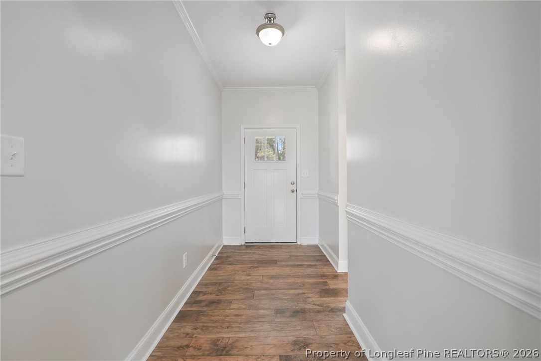 5150 J T Matthews Road Godwin, NC 28344 - Photo 8 of 50 a view of a hallway with wooden floor and a bathroom