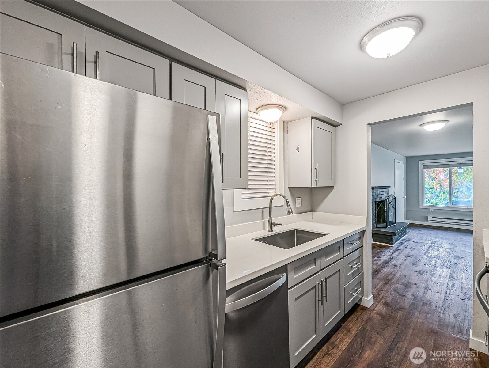 5954 Fauntleroy Way Southwest Seattle, WA 98136 - Photo 8 of 17 a kitchen with stainless steel appliances granite countertop a refrigerator a sink and white cabinets