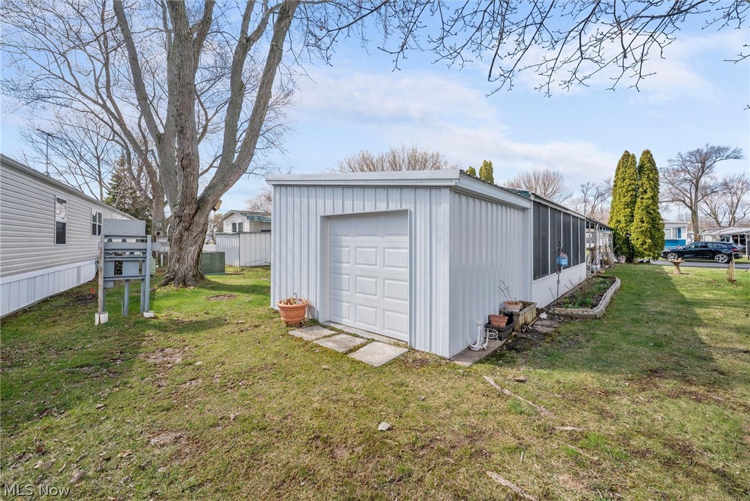 1623 Northeast Catawba Road, Unit 160 Port Clinton, OH 43452 - Photo 25 of 28 Attached storage shed and yard