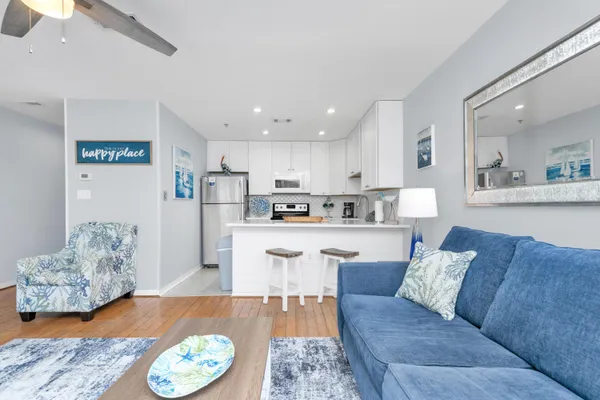 a kitchen with a sink a stove and white cabinets