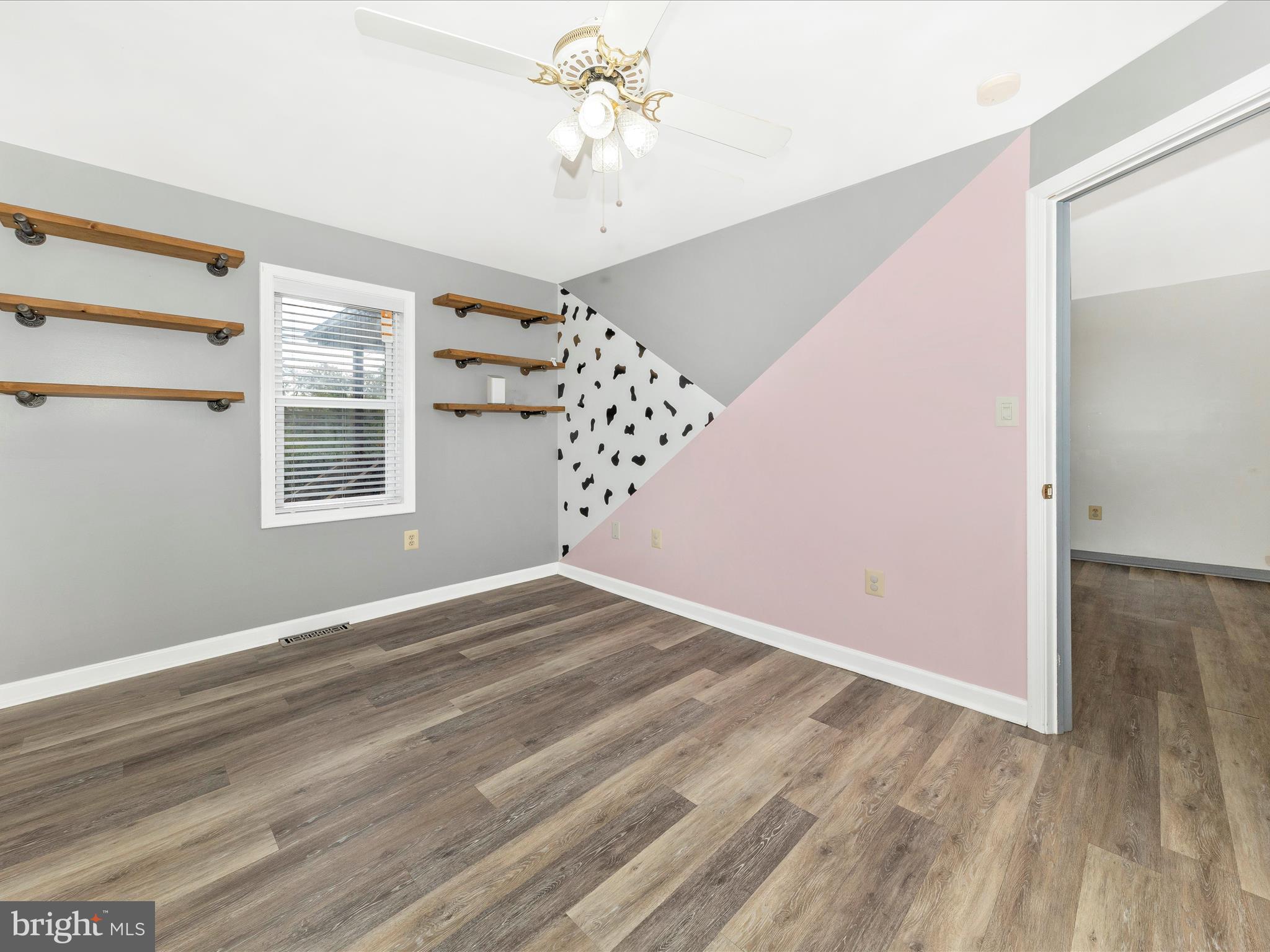 9320 Rocky Ridge Road Rocky Ridge, MD 21778 - Photo 14 of 54 a view of a livingroom with wooden floor a ceiling fan and window