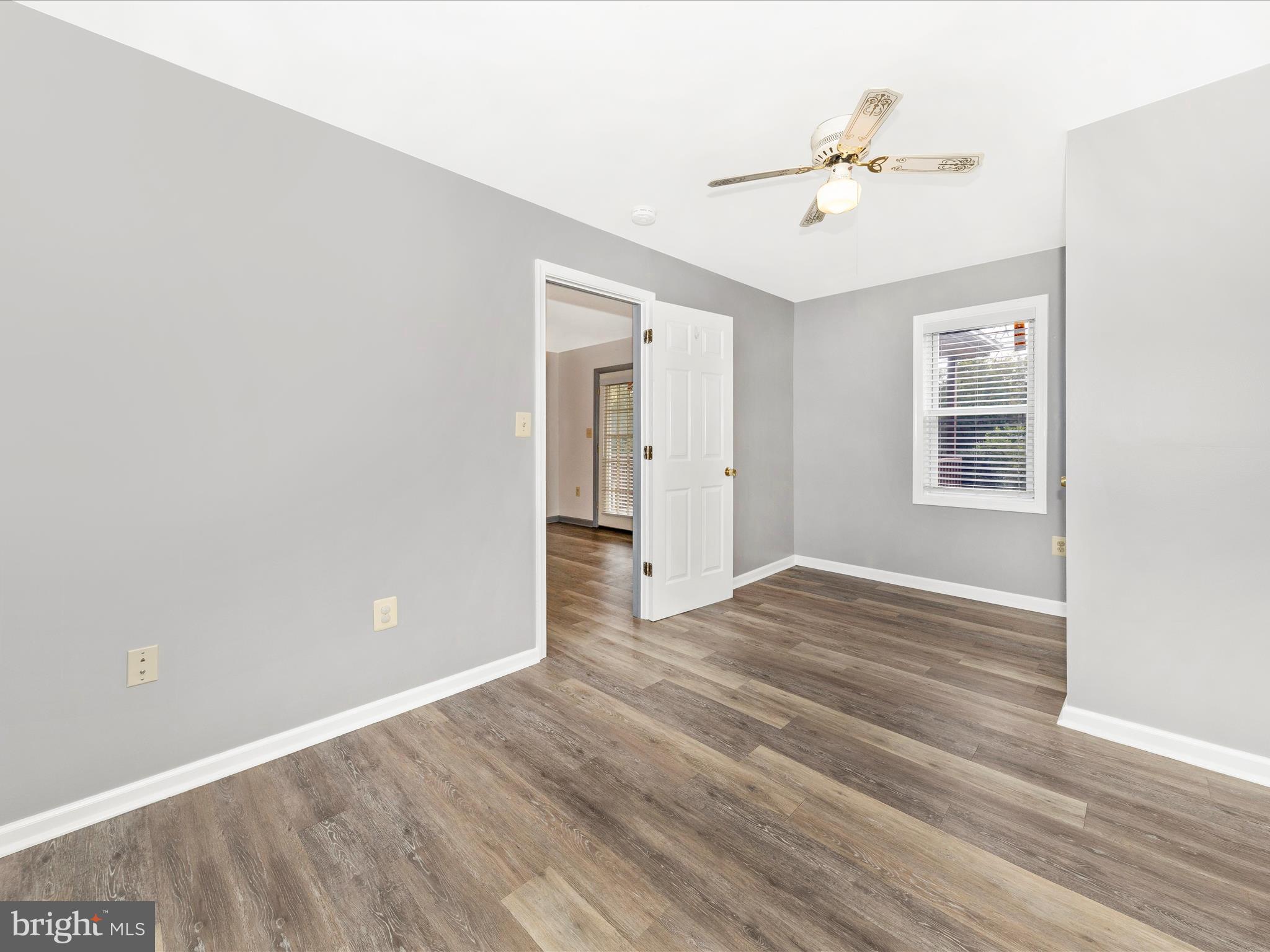 9320 Rocky Ridge Road Rocky Ridge, MD 21778 - Photo 18 of 54 a view of an empty room with wooden floor and a window