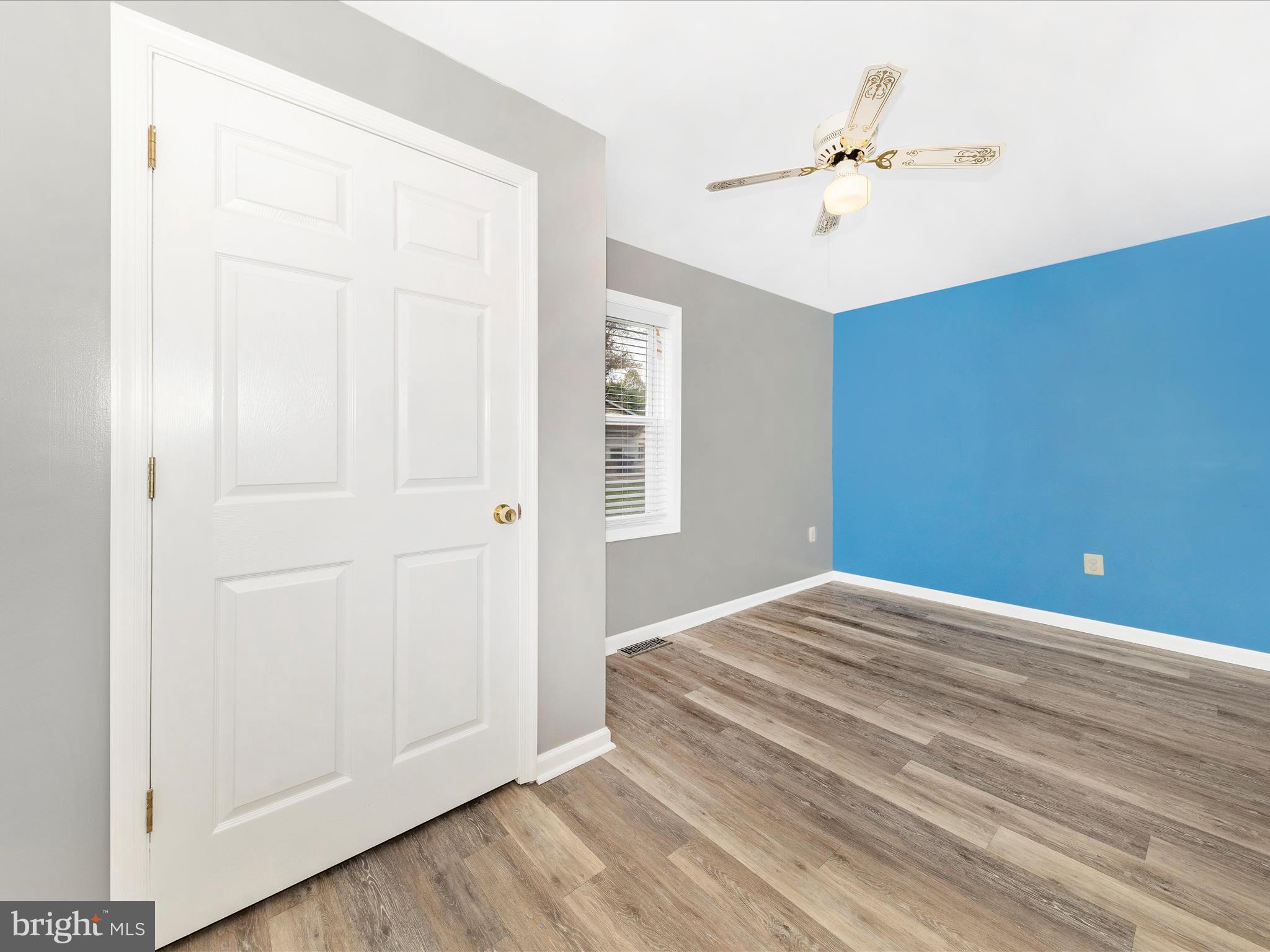 9320 Rocky Ridge Road Rocky Ridge, MD 21778 - Photo 19 of 54 a view of a livingroom with wooden floor and a ceiling fan