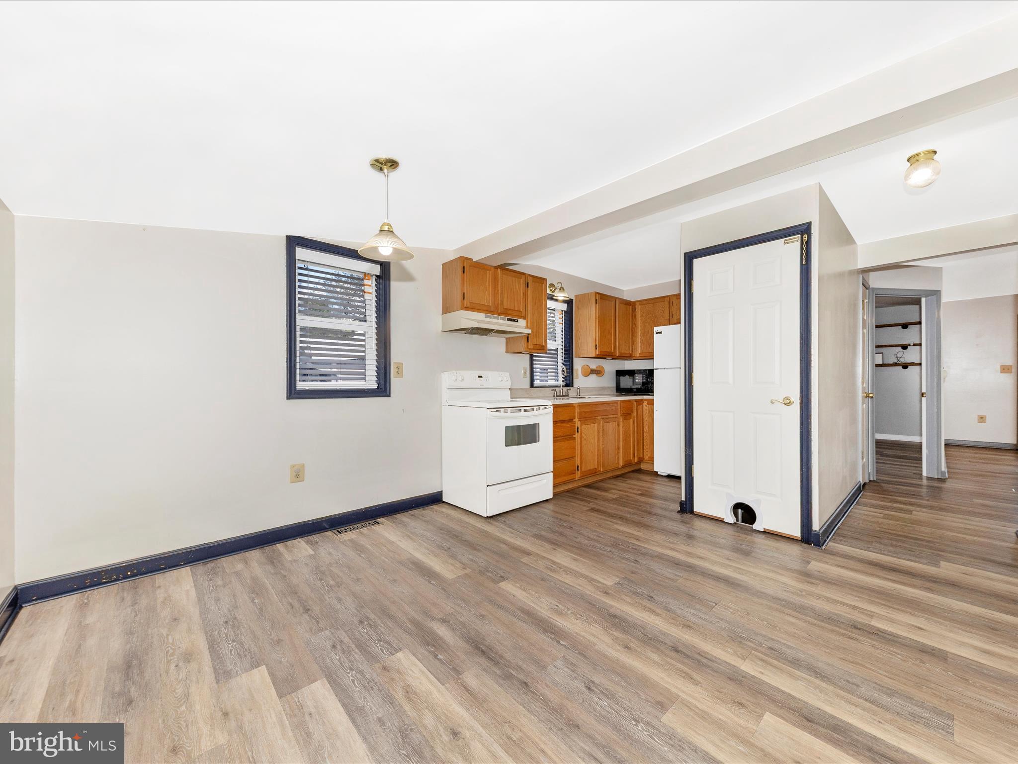 9320 Rocky Ridge Road Rocky Ridge, MD 21778 - Photo 23 of 54 a view of a kitchen with wooden floor and electronic appliances