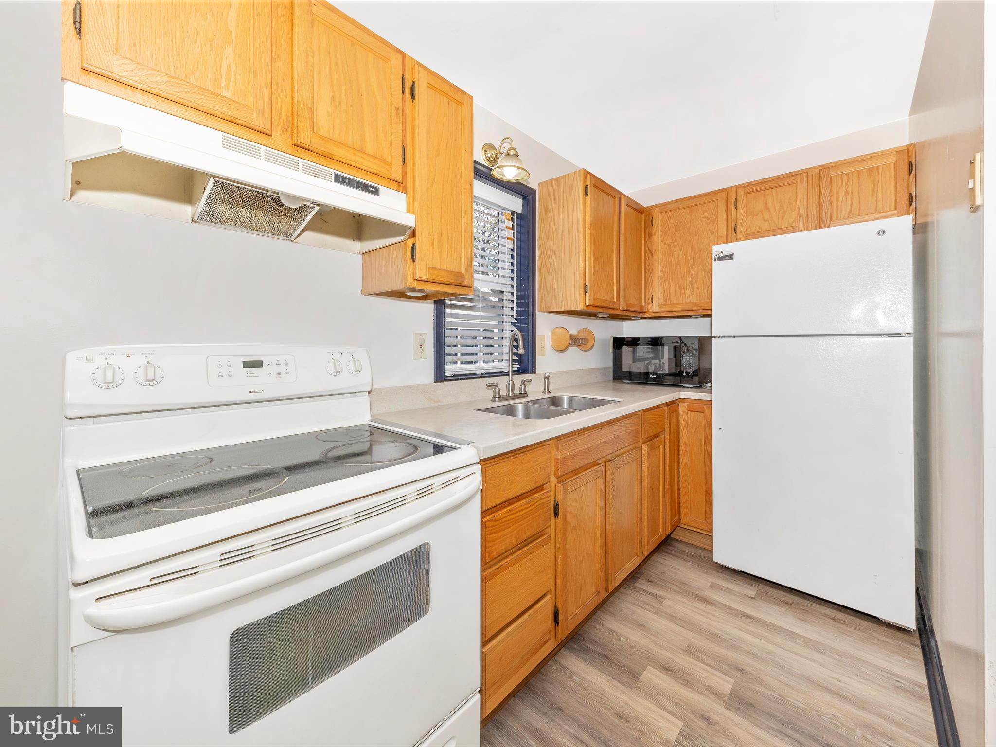 9320 Rocky Ridge Road Rocky Ridge, MD 21778 - Photo 24 of 54 a kitchen with cabinets appliances a sink and a window