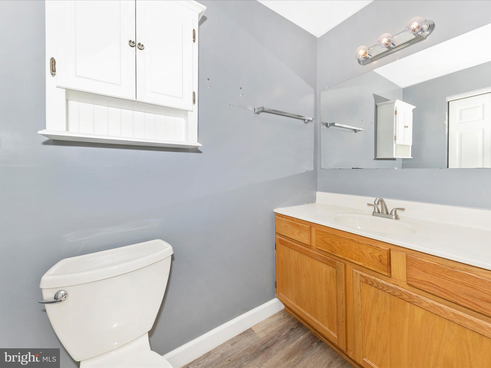 9320 Rocky Ridge Road Rocky Ridge, MD 21778 - Photo 33 of 54 a bathroom with a toilet sink and mirror